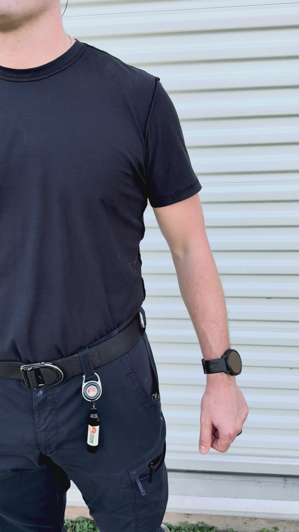 Video of firefighter wearing The Stink Stick reel clipped to his belt loop, stretching the retractable extender in three directions, which then automatically reels back in